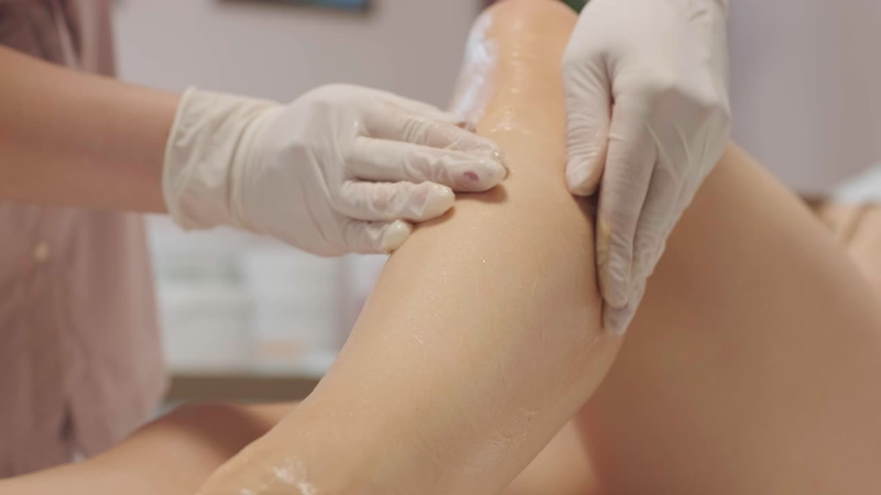 Laser epilation - hair removal procedure. Flash of diode laser hair removal, Beautician removes hair on beautiful female legs, Hair removal for smooth skin, laser procedure at beauty studio or clinic, Body care epilation treatment.