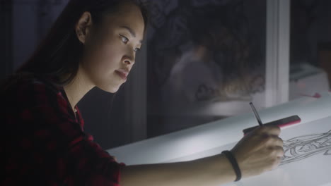 woman artist drawing at night