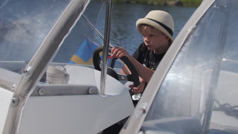 Young Boy Driving a Motorboat on a Sunny Day