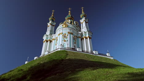 camera rises from behind wall to reveal st andrews church kiev in beautiful morning light