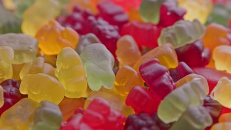 full frame looped spinning background of colorful jelly bear candies heap