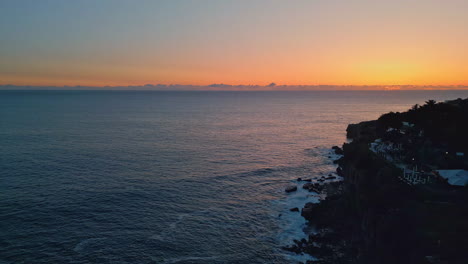 evening sky marine horizon drone view. tranquil deep ocean with cliff silhouette