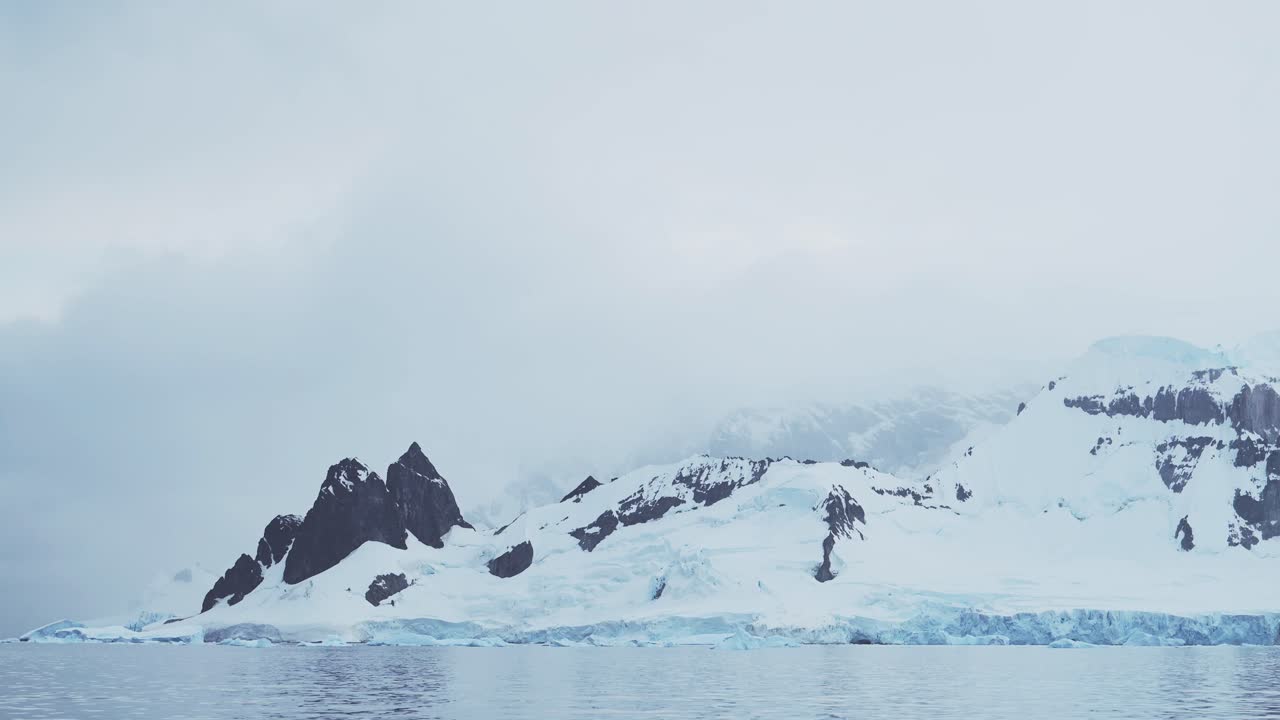Winter Mountains and Glacier on Coast, Coastal Scenery in Antarctica, Landscape and Seascape with Glacier Ice and Ocean Sea Water, Antarctic Peninsula Beautiful Dramatic Mountain Coastline Scene
