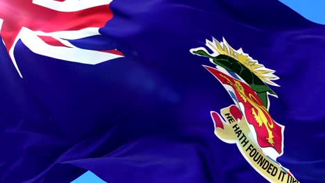 flag of the cayman islands waving at wind with blue sky, loop