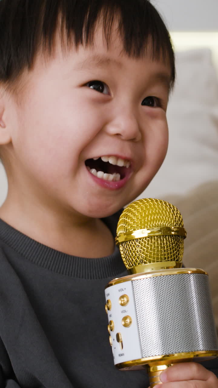 Child Singing into a Portable Microphone