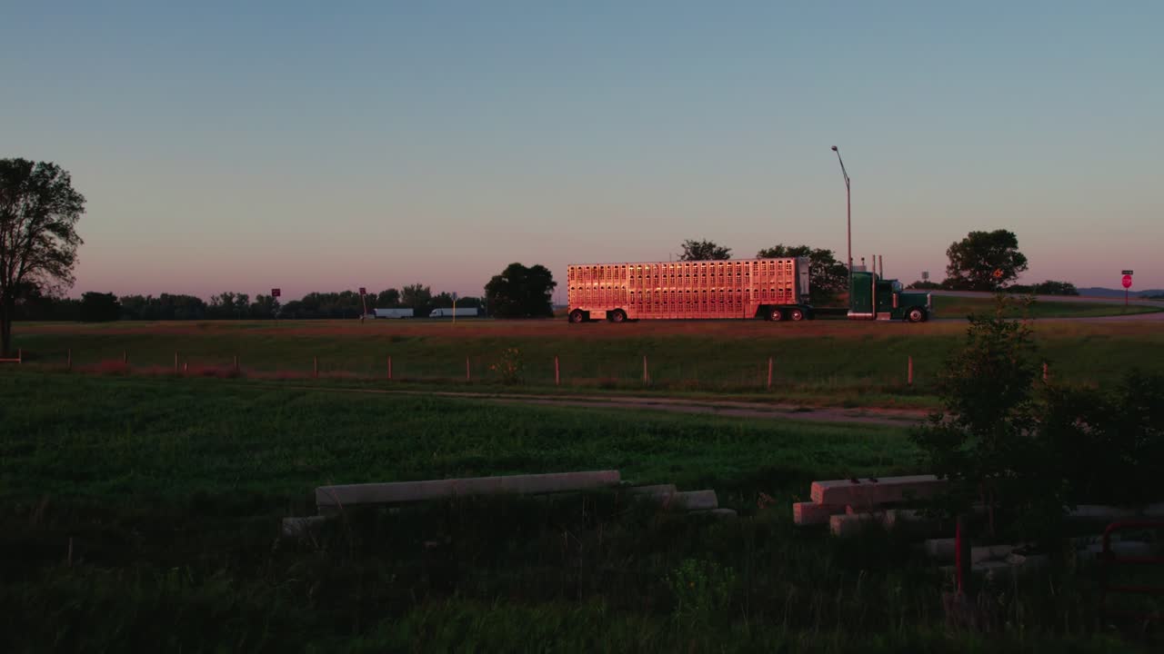 Parked Livestock Semi Truck Resting on I-80 Highway Ramp at Sunset in Nebraska
