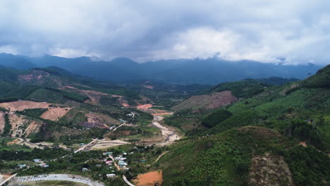 Aerial-panorama,-hill-valley-deforestation-clearance-for-agriculture-farm-fields