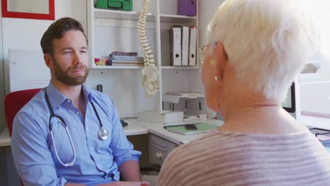 doctor examining a senior woman in a retirement home