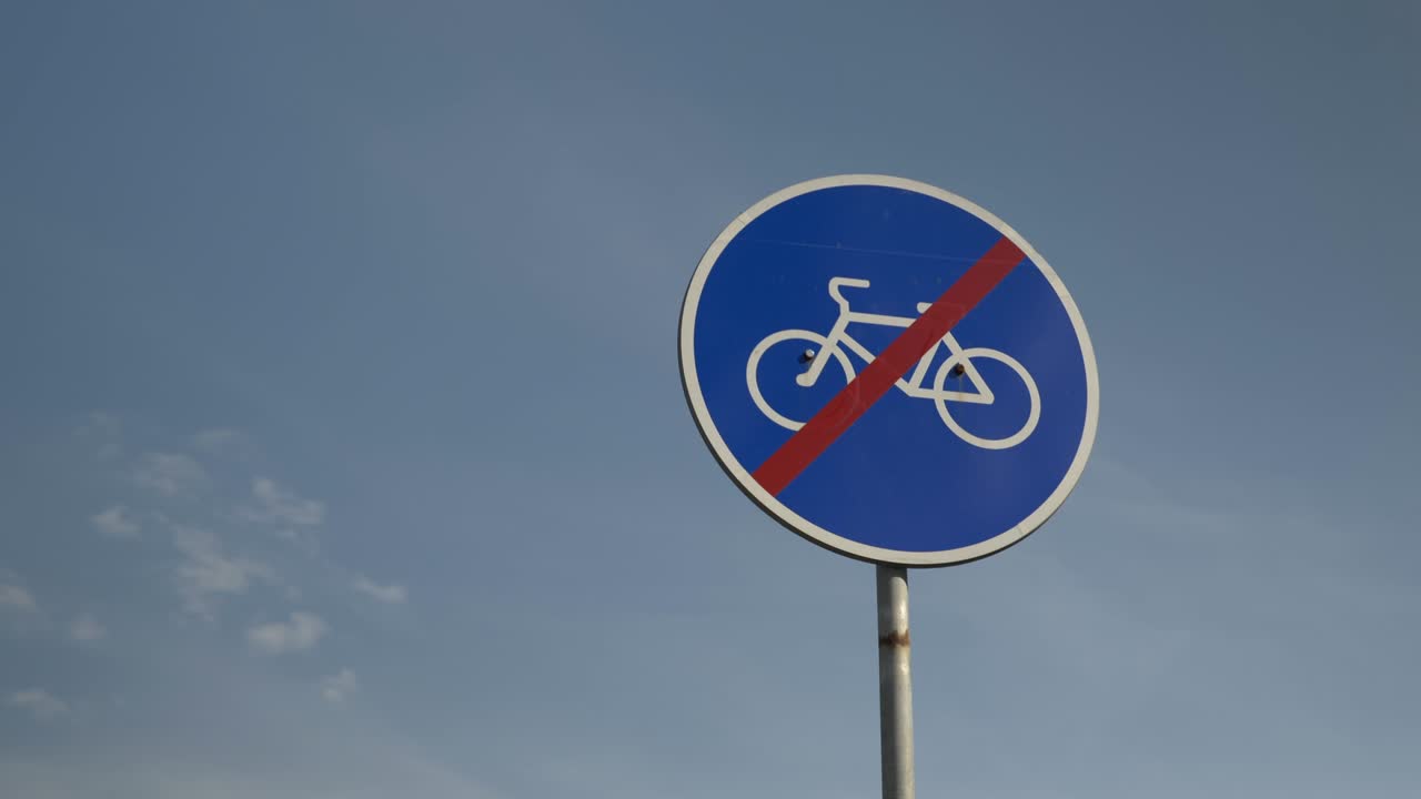 "no cycling" sign against blue sky. No cyclists' travel sign. "No bicycles" sign. Signboard forbidding bicycles to move along pedestrian street