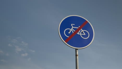 "no cycling" sign against blue sky. no cyclists' travel sign. "no bicycles" sign. signboard forbidding bicycles to move along pedestrian street