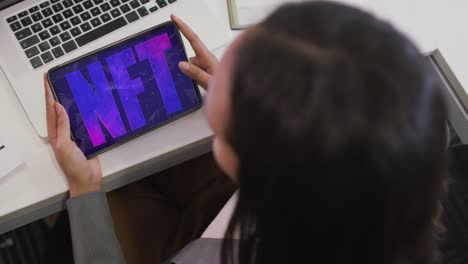 african american businesswoman using tablet for video call with nft text