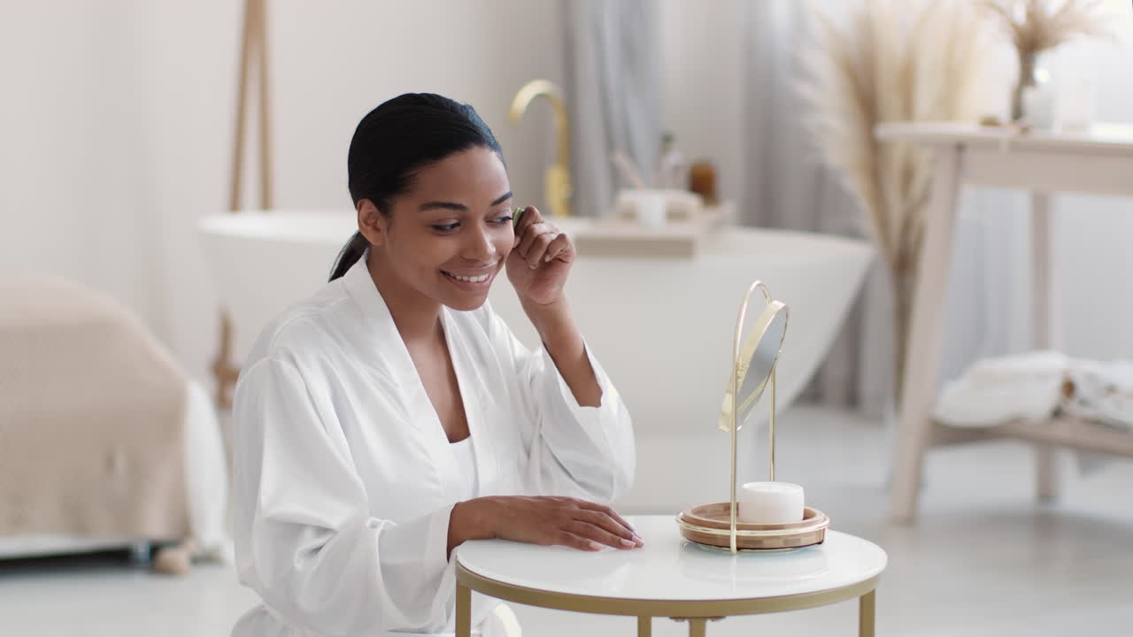 Femme appliquant des soins du visage dans une salle de bain