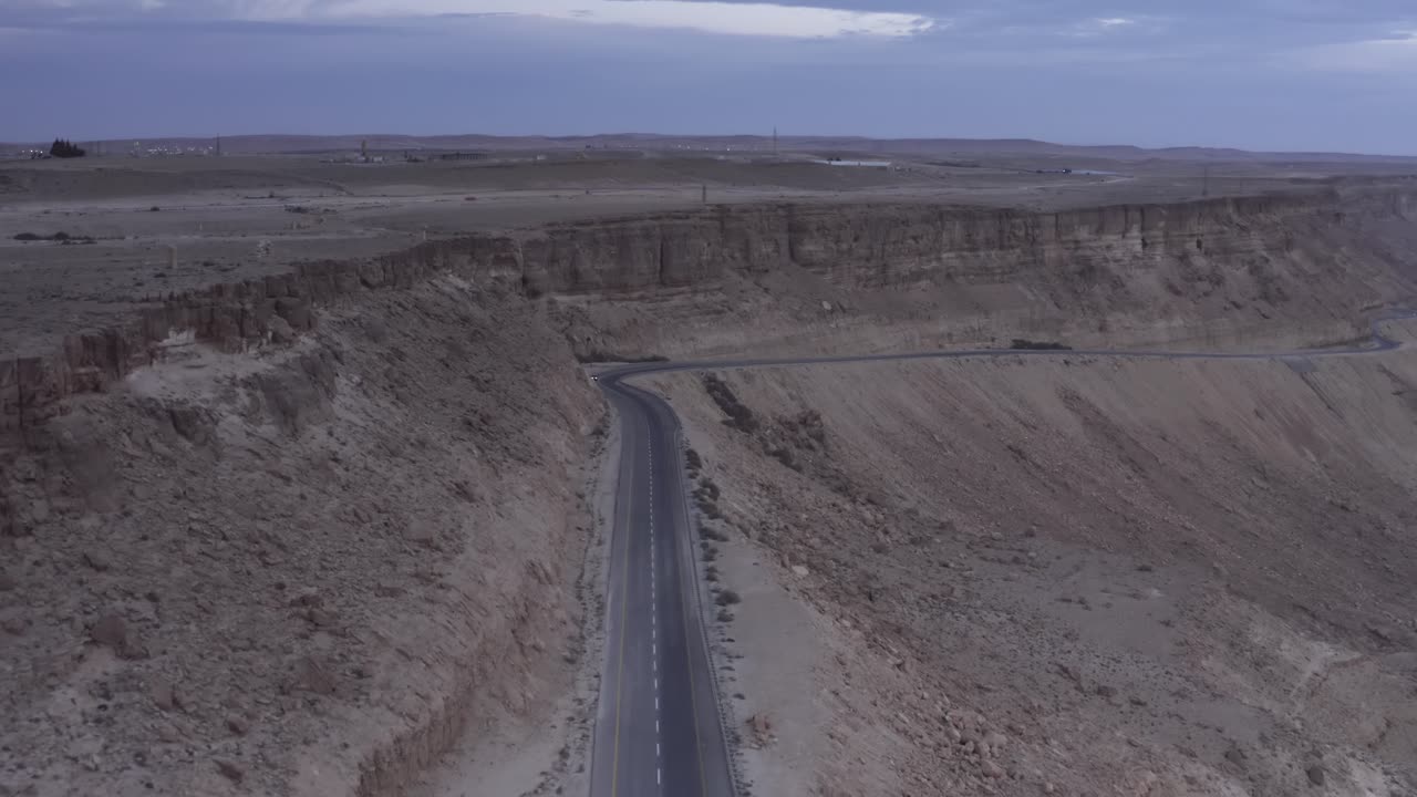 Aerial View of a Road Winding Through a Desert Canyon