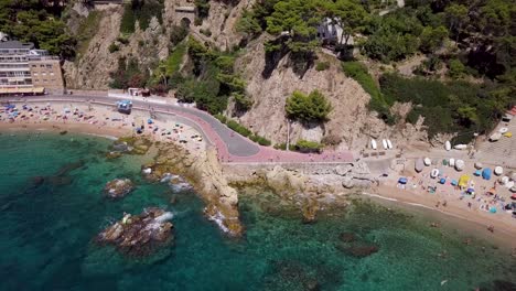 clear sea of lloret de mar from above by drone zoom out