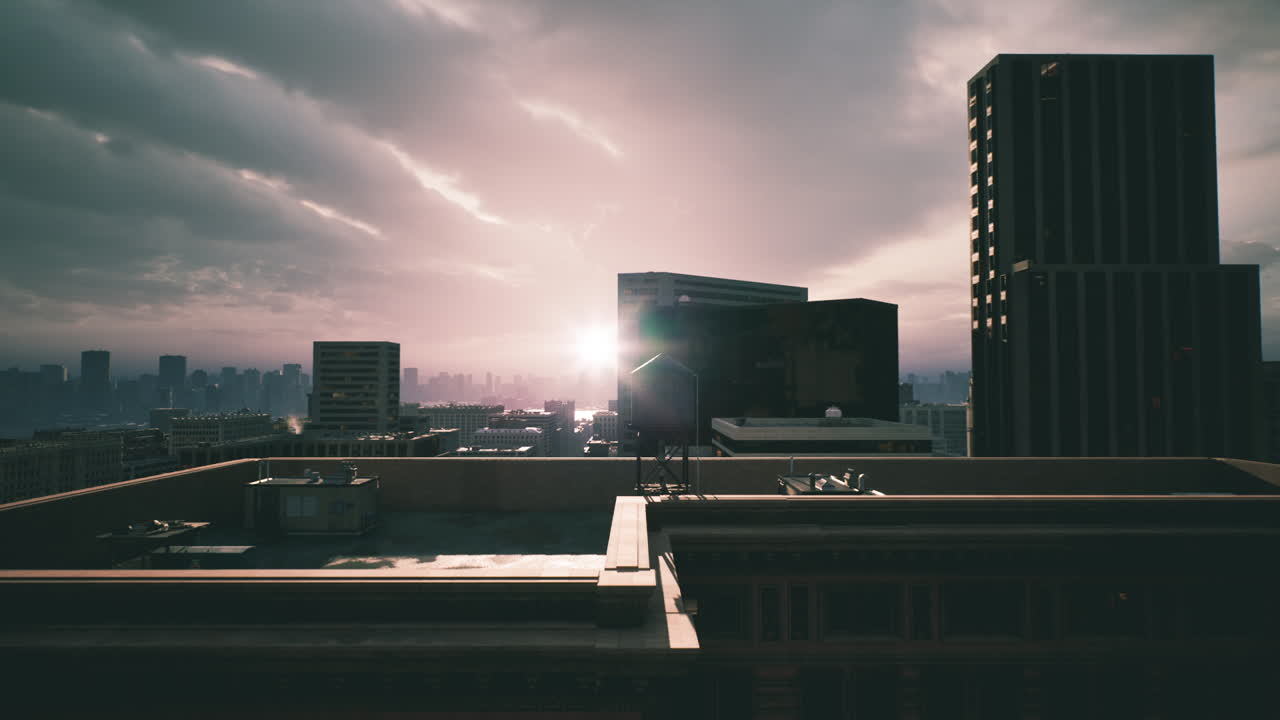 Sunset over a city skyline with modern buildings and cloudy skies