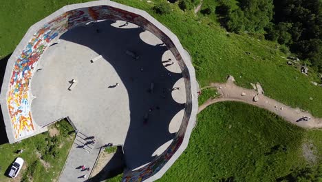 cinematic drone shot from top down, zooming out from an ancient monument in georgia in front of beautiful mountains