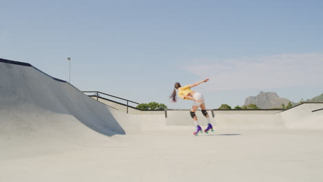 a young female and male roller skater jumping