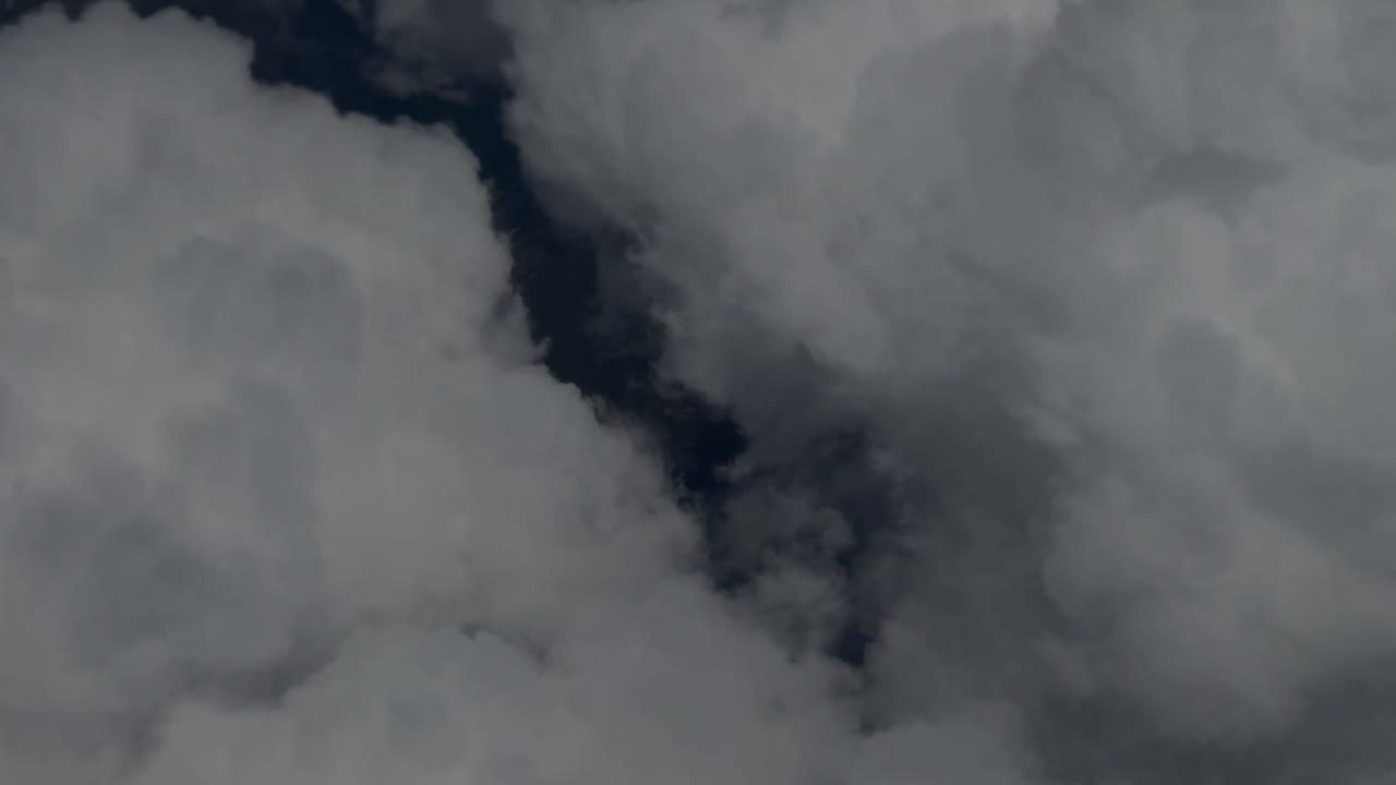 Aerial view of a mountainous landscape partially covered by clouds