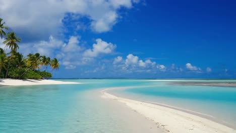palm trees growing on a beautiful white sand beach leading to crystal clear turquoise water under a bright blue sky with some clouds, creating a perfect tropical paradise