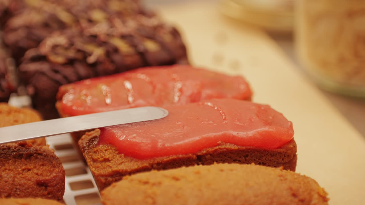 Artezan bread with red strawberry jam on top, fresh bake double chocolate banana artesian bread in bakery shop close-up. Artisan bread is making by skill bakers using natural and high-quality ingredients. Food with health and flavour benefits. Sweet breads for dessert and breakfast