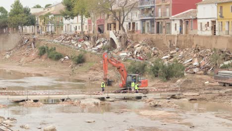 construction repairing storm-damaged riverbed in rambla del poyo, valencia