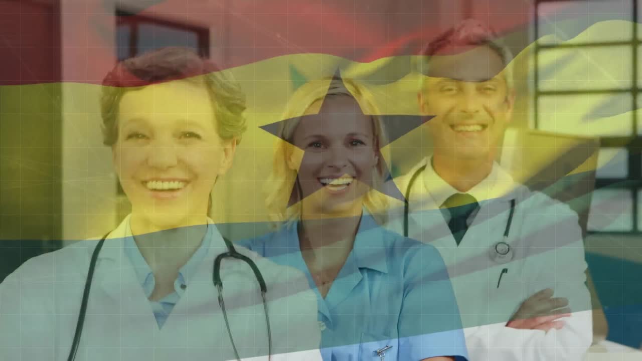 Animation of waving ghana flag over team of diverse doctors and health workers smiling at hospital