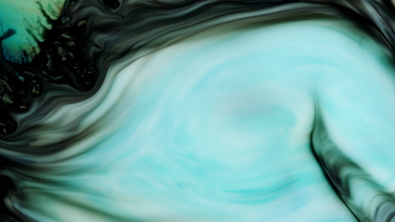 The blue gives color to the flow of white paint and the mixing of colors occurs in beautiful slow motion