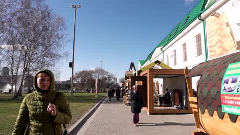 outdoor market with wooden booths in a city park