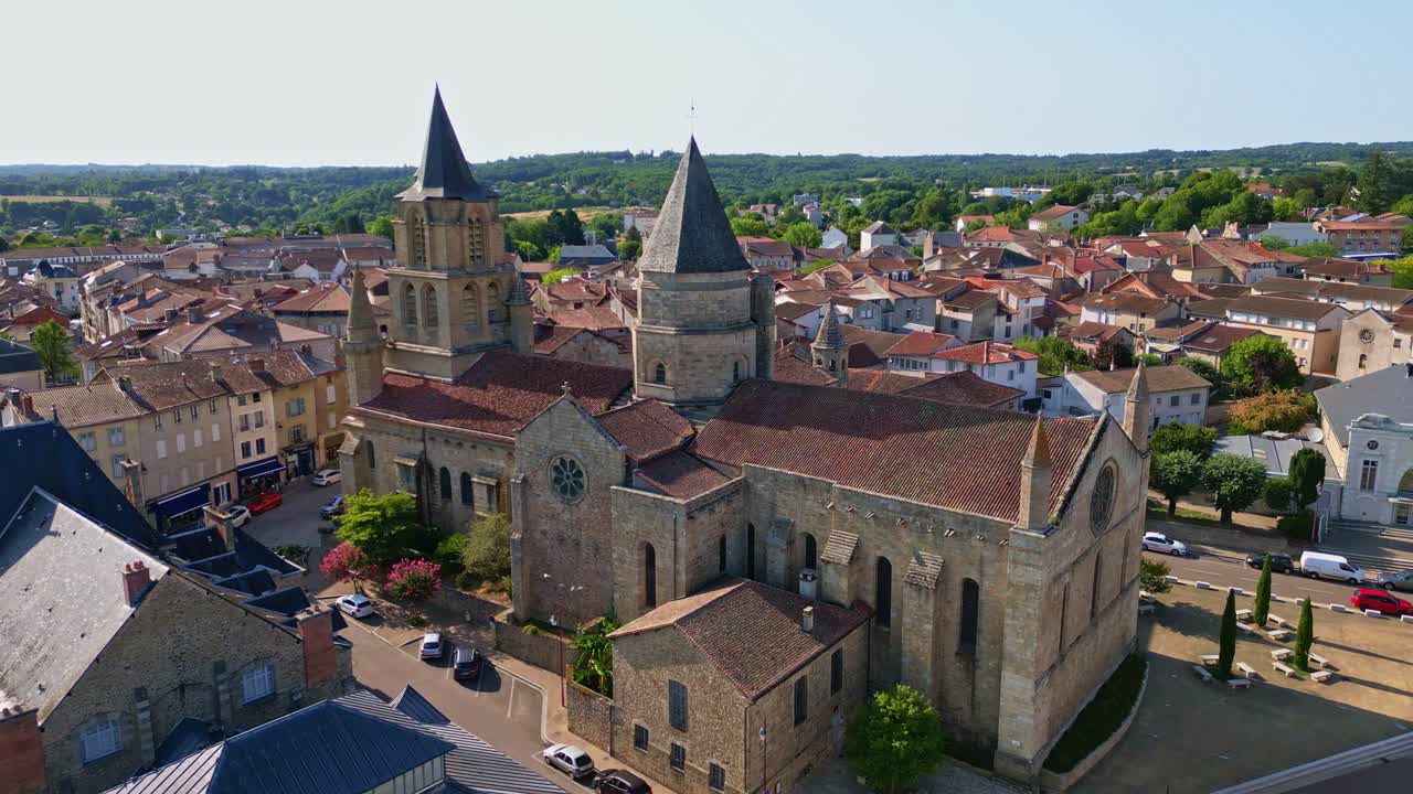Collegiate Church of Saint-Junien, France. Aerial drone backward, cityscape