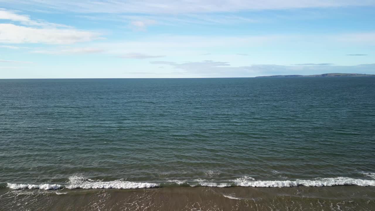 Aerial over sandy beach and calm waters of the Atlantic in Ireland
