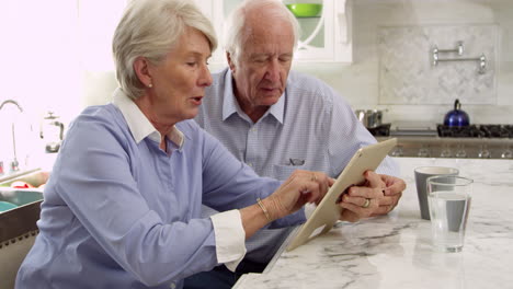 Senior-Couple-Use-Digital-Tablet-For-Purchase-Shot-On-R3D