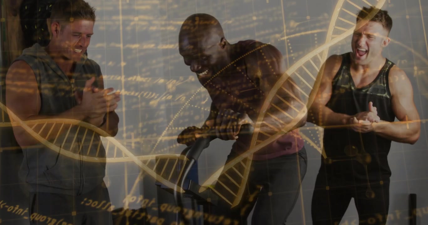 Pedaling rider in maroon tank leaning in studio, trainers clapping by stationary bike with gold DNA