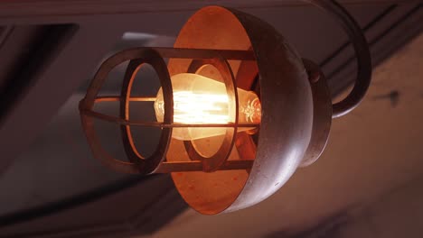 industrial light fixture with glowing edison bulb
