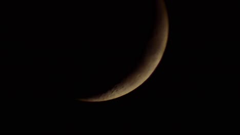 dark dramatic bright glowing moon with fast moving storm clouds passing across