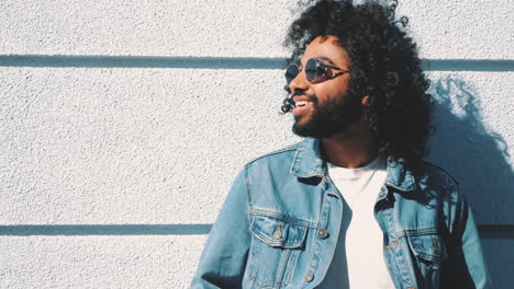 man wearing denim jacket and sunglasses