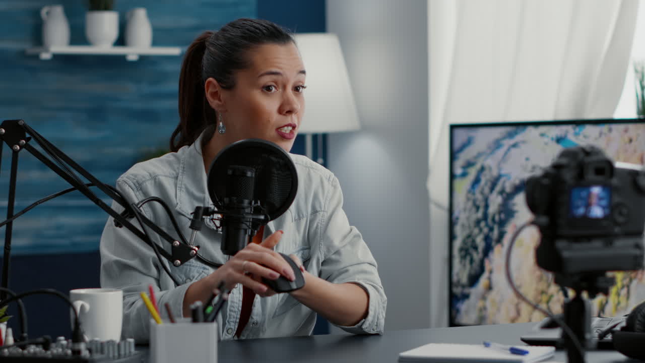 Tech influencer reviewing modern wireless mouse while presenting it to audience