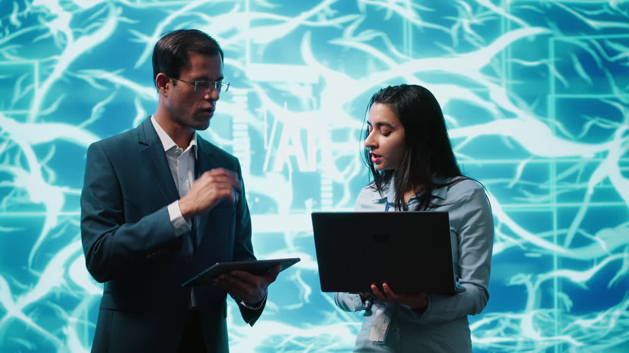 Coworkers solving tasks on laptop and tablet, running AI software