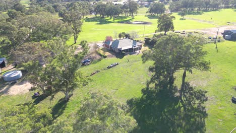 aerial view of a rural property with farmhouse and sheds