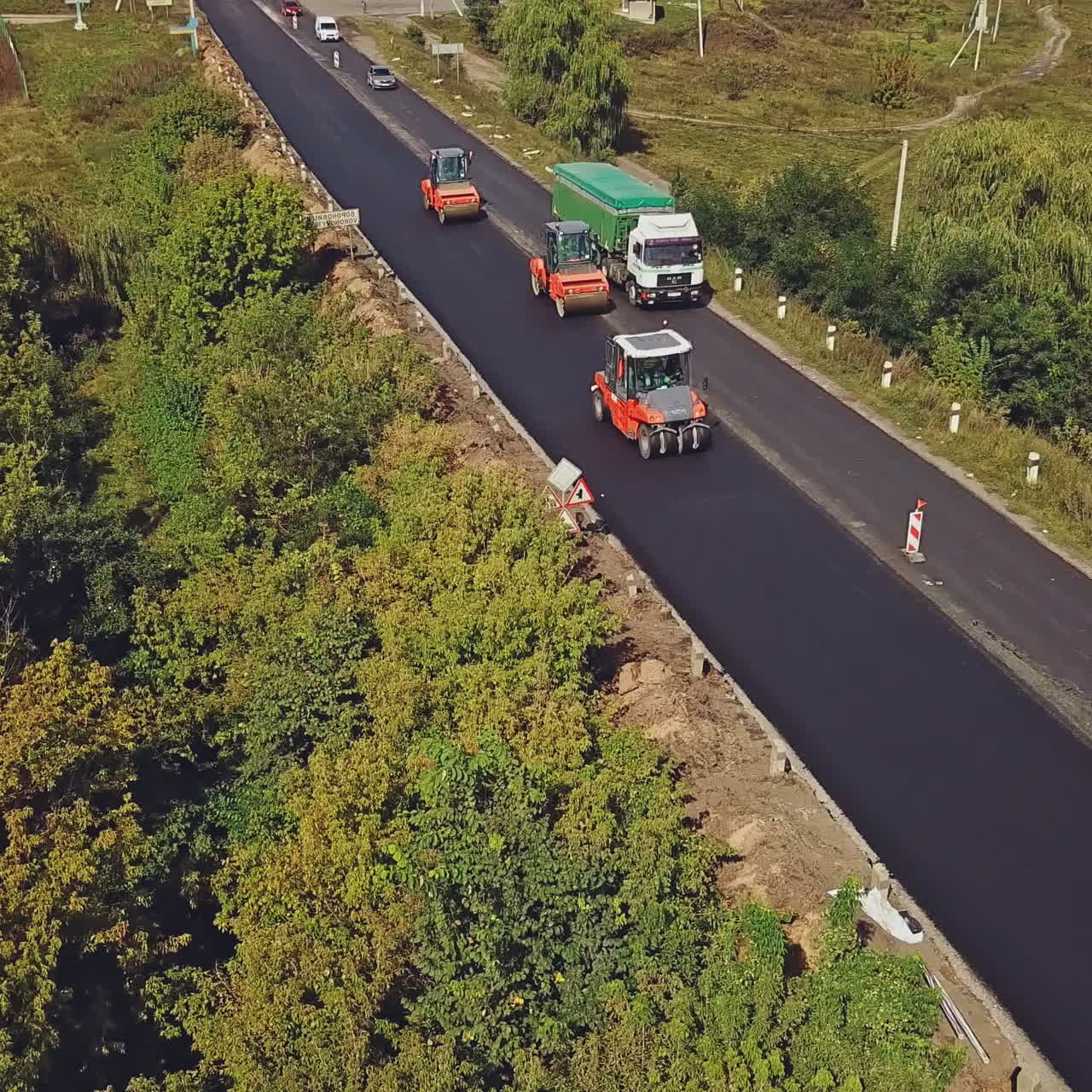 Aerial view on the new asphalt road under construction. Laying a new asphalt on the road.