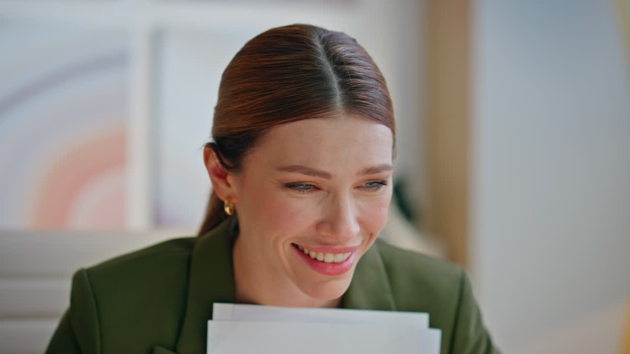 Closeup cheerful boss videochatting laptop in office. Smiling lady face talking