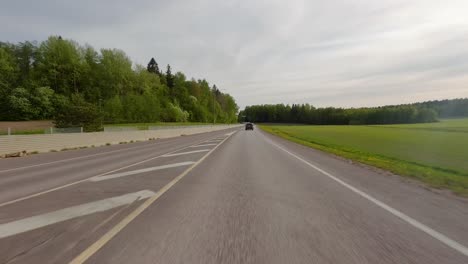 point of view perspective of a car driving rapidly on a calm country road