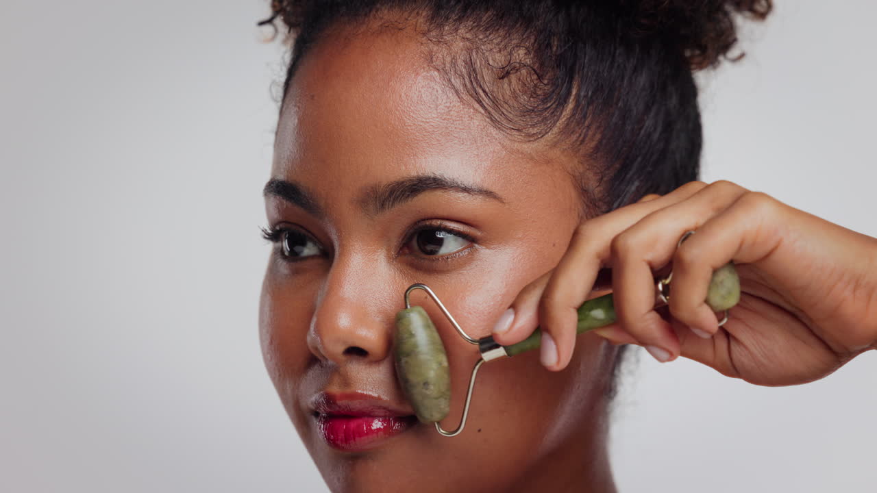 Woman using a jade roller for skincare