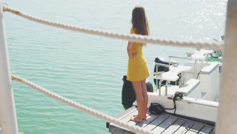 Side-view-of-a-teenage-Caucasian-girl-enjoying-the-view-harbor-side