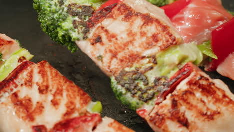 cooking salmon skewers with vegetables