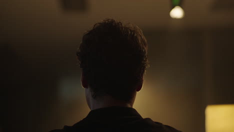 man talking on the phone in a dark room