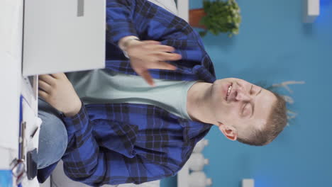 vertical video of home office worker man talking motivationally to camera.