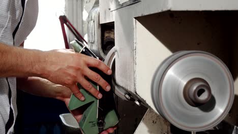 craftsman using grinder machine while making shoes