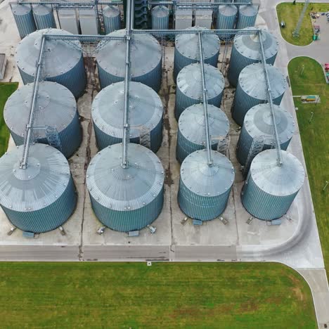 large steel elevators. granaries for grain on the field. silver silos on agricultural factory. view from above.