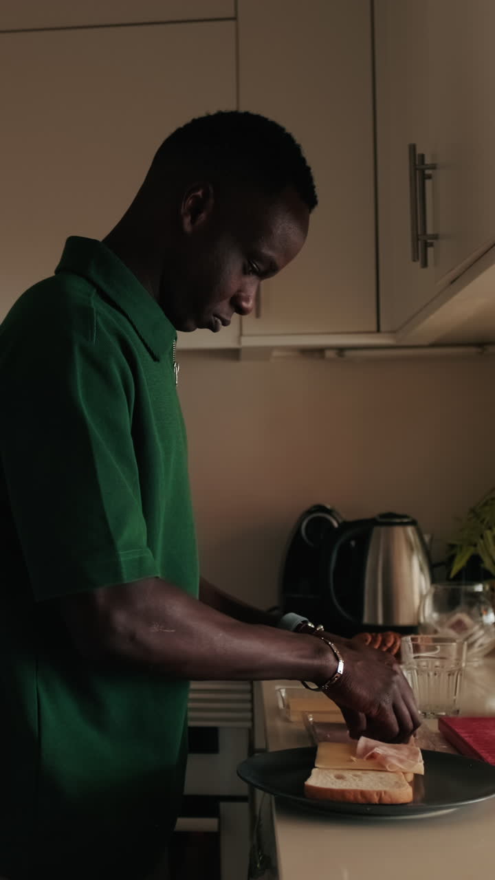 Young Man Preparing a Sandwich in a Home Kitchen