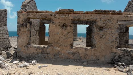 ruin of an old light house in the caribbean island with cloudy sky and ocean background